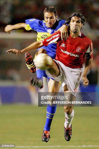 Alejandro Delgado del equipo argentino Boca Juniors disputa el balon con el brasileno Fernandao, del Internacional, 19 de octubre de 2005, en partido...