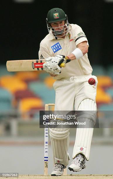 George Bailey of the Tigers prepares to hit out during day four of the Pura Cup match between the Queensland Bulls and Tasmanian Tigers at the Gabba...