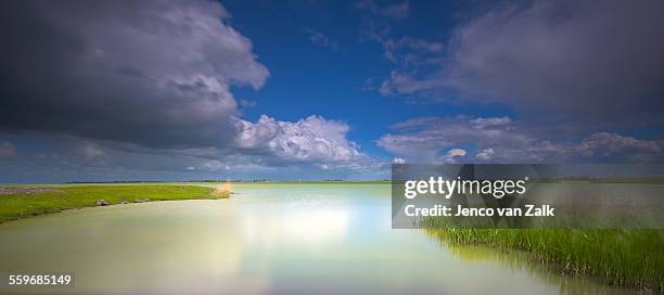 clouds over water - friesland stock pictures, royalty-free photos & images