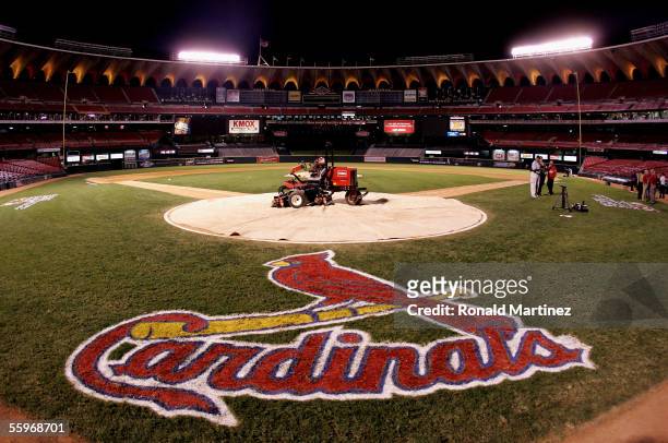 Lawn mower is shown on home plate with a tarp as fans leave the stands following the St. Louis Cardinals 5-1 loss the Houston Astros during Game Six...