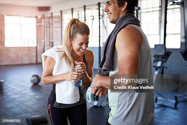 two gymters laughing after gym session - couple in a train stock pictures, royalty-free photos & images