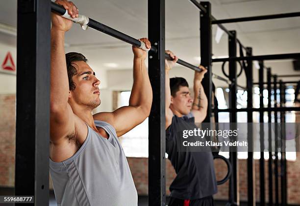 men doing pull-up's at gym gym - chin ups stock pictures, royalty-free photos & images