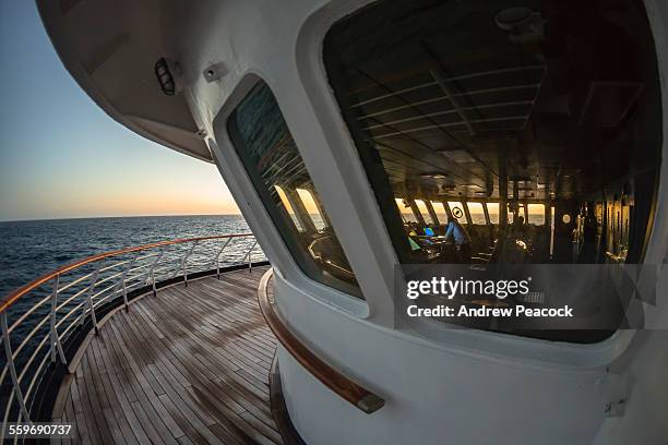 a ship's officer is standing in the bridge - ship's bridge imagens e fotografias de stock