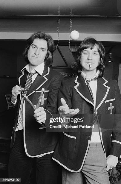 Singer-songwriter Ray Davies and his brother, guitarist Dave Davies, of English pop group The Kinks, dressed as schoolboys, 20th January 1976. Ray is...