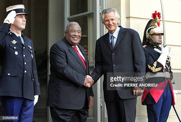 Haitian Prime Minister Gerard Latortue shakes hands with his French counterpart Dominique de Villepin upon his arrival at the Matignon Hotel in Paris...