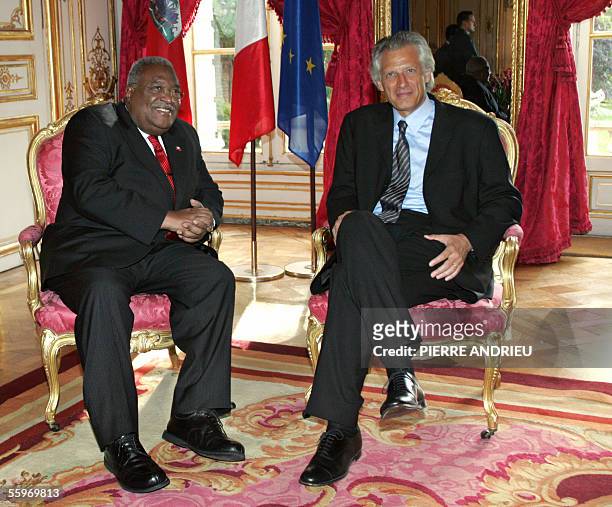 Haitian Prime Minister Gerard Latortue poses with his French counterpart Dominique de Villepin upon his arrival at the Matignon Hotel in Paris for...