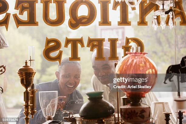 mature couple window shopping - couple antique shopping stock pictures, royalty-free photos & images