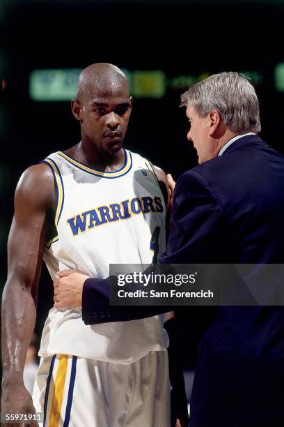 Chris Webber of the Golden State Warriors talks with head coach Don Nelson during a timeout during an NBA game against the Philadelphia 76ers on...