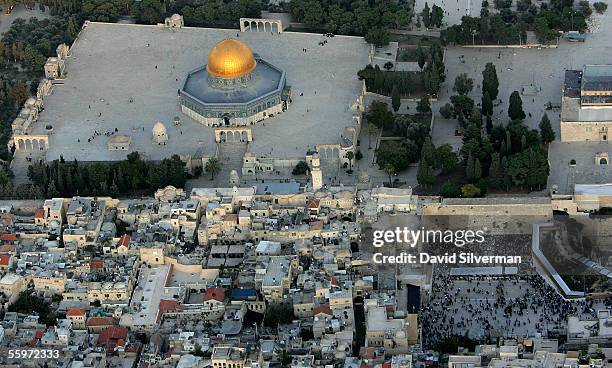 The golden Dome of the Rock Islamic shrine dominates the Temple Mount on which it stands, and at right, the Western Wall, Judaism's holiest shrine...