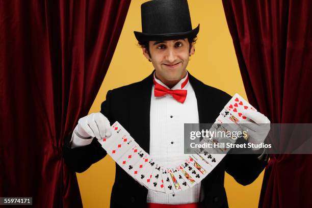 magician performing card trick - magician cards stock pictures, royalty-free photos & images