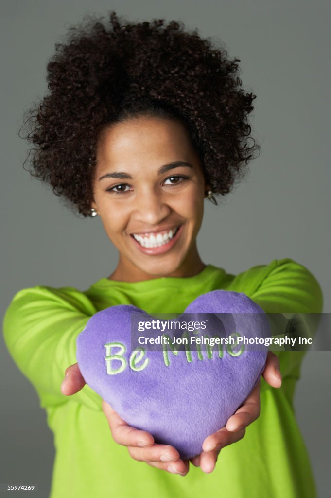 Young woman holding heart