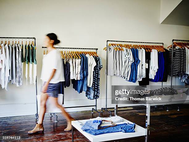 customer with shopping bag walking in boutique - clothes store fotografías e imágenes de stock