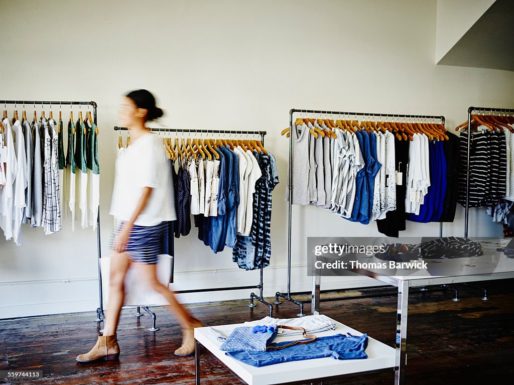 Customer with shopping bag walking in boutique