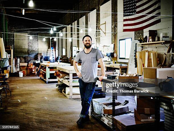 smiling leatherworker standing in studio - american flag on stand stock pictures, royalty-free photos & images