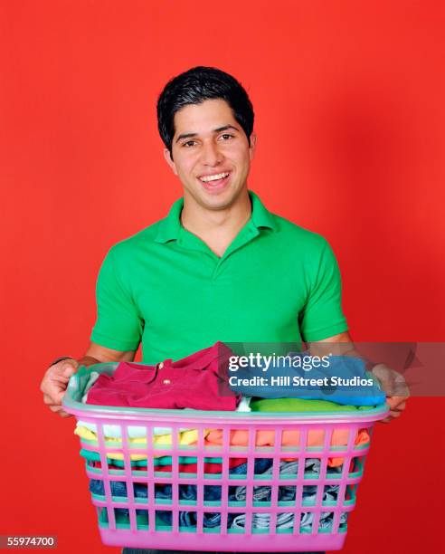 man holding basket with folded clothes - carrying laundry stock pictures, royalty-free photos & images