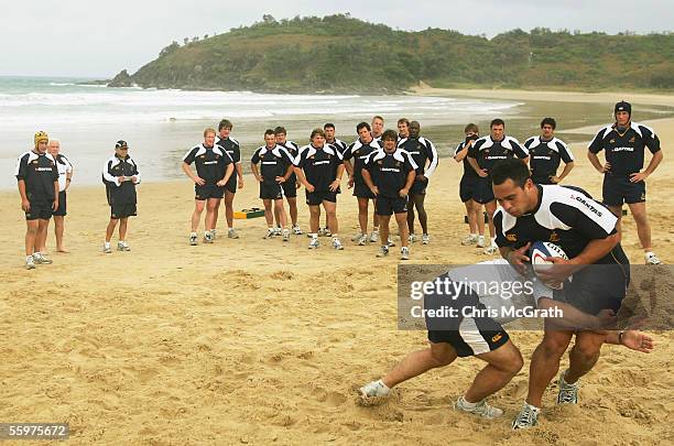 Wallaby players watch on during the Wallabies beach training session on day three of the Wallabies Spring Training Camp held at Camp Wallaby October...