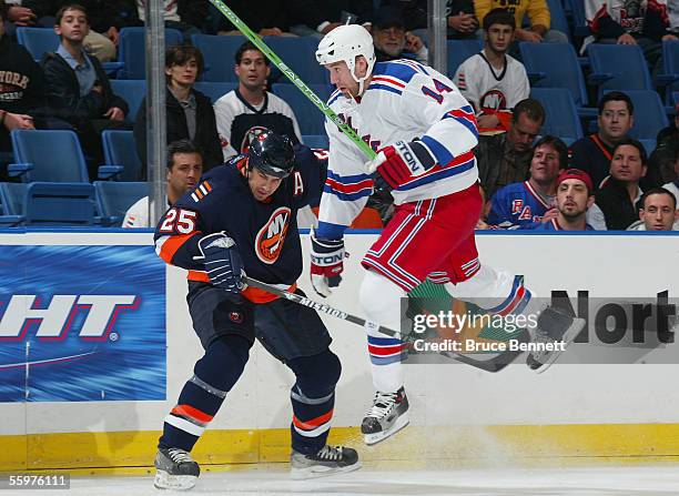 Jason Ward of the New York Rangers leaps against defenseman Brad Lukowich of the New York Rangers on October 20, 2005 at the Nassau Coliseum in...