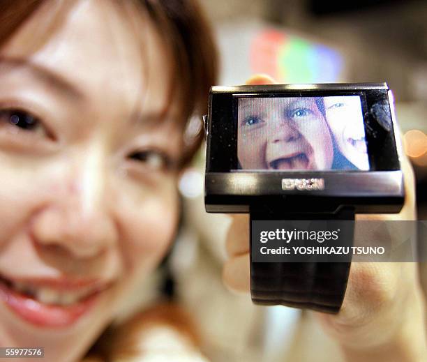 An employee of Sanyo Epson Imaging Devices Corporation displays the prototype model of the ultra low power consumption LCD display for the wrist...