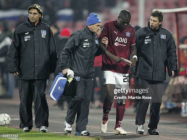 Guy Demel of Hamburg walks off the pitch injured with Uwe Eplinius and Ronny Teuber as Ralf Zumdick looks on during the UEFA Cup Group A match...