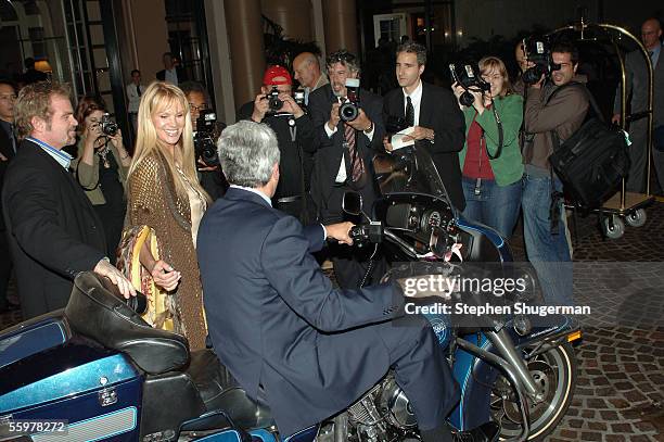 Host Jay Leno and Rodney Dangerfield's widow Joan Dangerfield pose for photographers with Mr. Leno's motorcyle at the David Geffen School of Medicine...