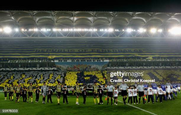 The teams of Fenerbahce and Schalke march into the stadium before the Champions League Group E match between Fenerbahce and Schalke 04 at the Sukru...