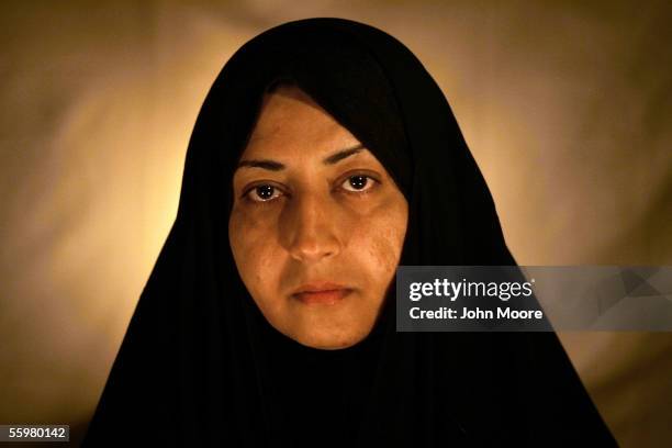 Dujail widow Amal Abed al Hadi Hamdi poses for a photograph on October 20, 2005 in Dujail, Iraq. Her husband, Hamed Abass Hasson was a 29-year-old...