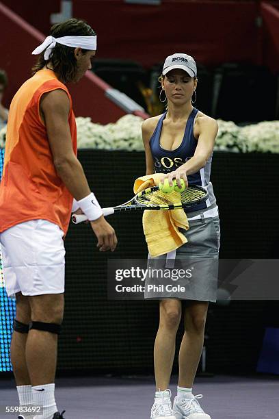 Rafael Nadal of Spain collects his balls from the ball girl during the match against Robby Ginepri of America during the Semi- Final of the ATP...