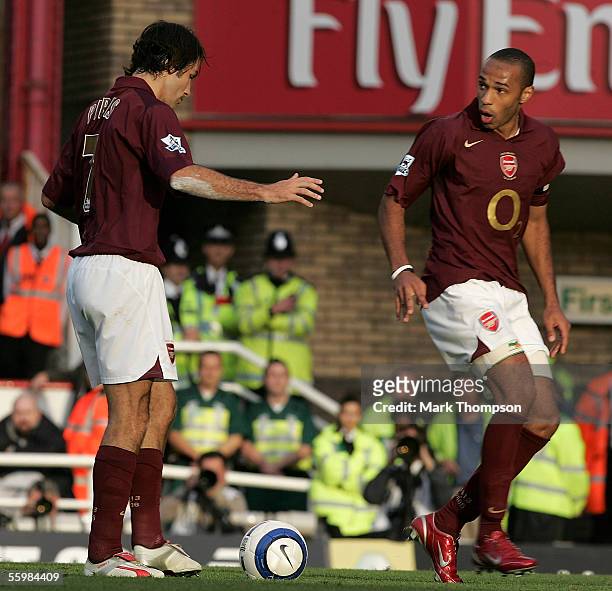 Robert Pires of Arsenal looks at Thierry Henry after the confusion between them caused them to miss a penalty during the Barclays Premiership match...