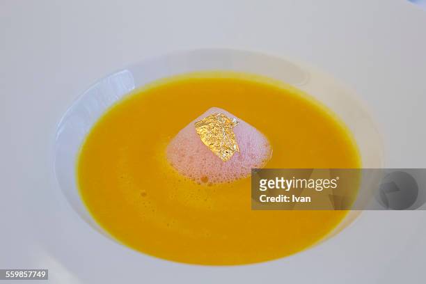 the luxury french carrot soup with goldleaf - molecular gastronomy stock pictures, royalty-free photos & images