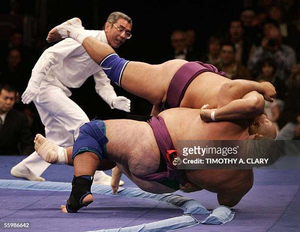 Ronny Allman of Norway throws Desz Libor of Hungary out of the ring, or dohyo, during the "World S.U.M.O. Challenge-Battle of the Giants" at Madison...