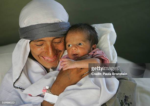 Arshada Bibi holds her baby boy, born on the day of the earthquake, at the Italian Red Cross field hospital October 23, 2005 in Mansehra, Pakistan....