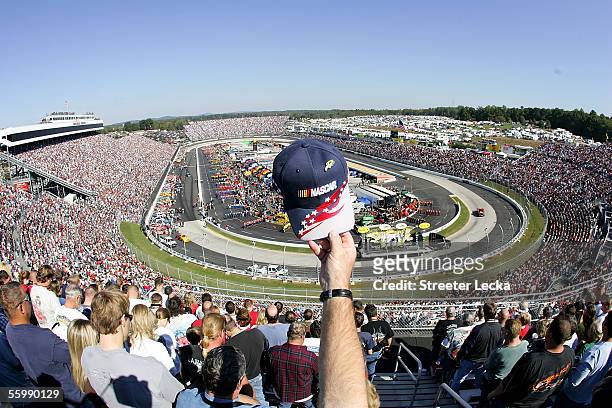 Fan waves a hat during the National Anthem during the NASCAR Nextel Cup Subway 500 on October 23, 2005 at Martinsville Speedway in Martinsville,...