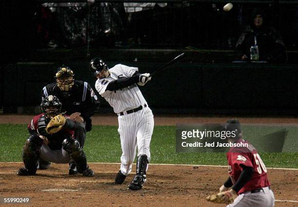 Paul Konerko of the Chicago White Sox hits a grand-slam home run against pitcher Chad Qualls of the Houston Astros in the seventh inning during Game...