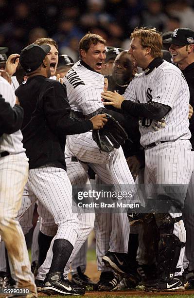 Scott Podsednik of the Chicago White Sox celebrates with his teammates after hitting a game winning home run off of Brad Lidge during the bottom of...