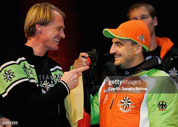 Markus Wasmeier and Georg Hackl share a joke during the Presentation of the official Turin 2006 wardrobe to the German Winter Olympics Team on...