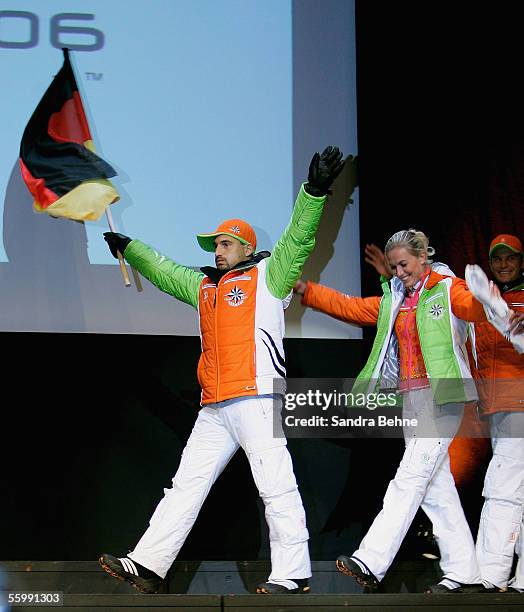 Georg Hackl waves the German flag during the Presentation of the official Turin 2006 wardrobe to the German Winter Olympics Team on October 24, 2005...