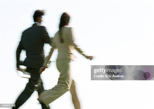 businessman and woman walking, rear view, blurred - couple walk white background stock pictures, royalty-free photos & images