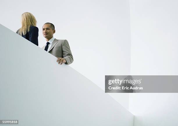 businessman and businesswoman standing face to face, low angle view - minimalism stock pictures, royalty-free photos & images