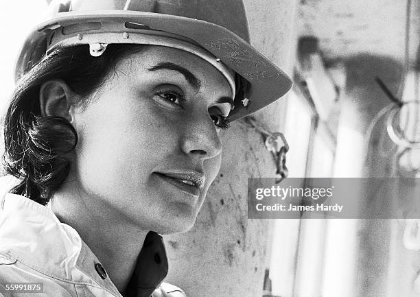 woman wearing hard hat, close-up, b&w - helmet worker stock pictures, royalty-free photos & images