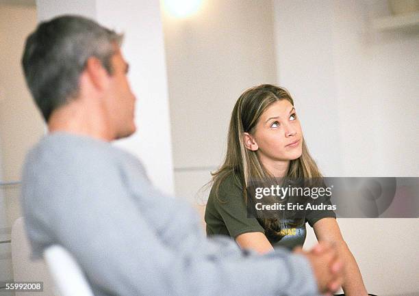 man and daughter sitting, man looking at daughter - eye roll stock pictures, royalty-free photos & images