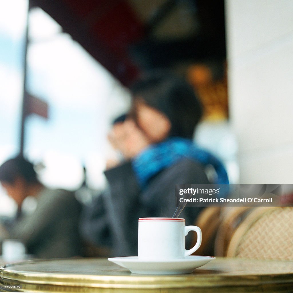 Cup of coffee on table at cafe terrace