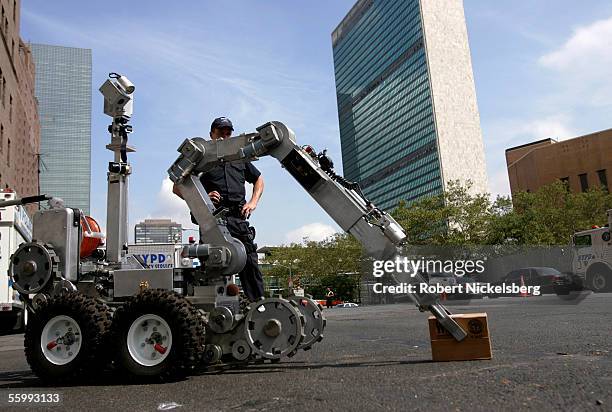 Officers from New York Police Department's Emergency Services Unit operate a remote controlled robot on a street near the United Nations building on...