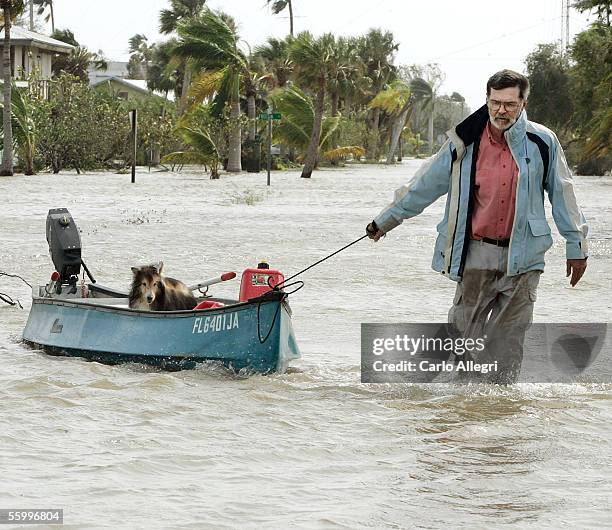 Steve Burke pulls his dog, Toby, down a flooded steet in a canoe after Hurricance Wilma arrived this morning October 24, 2005 in Everglades City,...