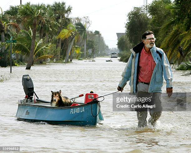 Steve Burke pulls his dog, Toby, down a flooded steet in a canoe after Hurricance Wilma arrived this morning October 24, 2005 in Everglades City,...