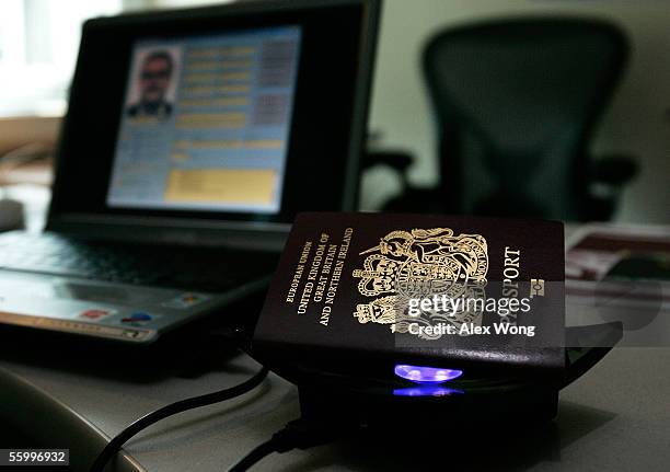 New British biometric European Union passport, which is embedded with a microchip, sits on top of a reader during a news briefing at the British...