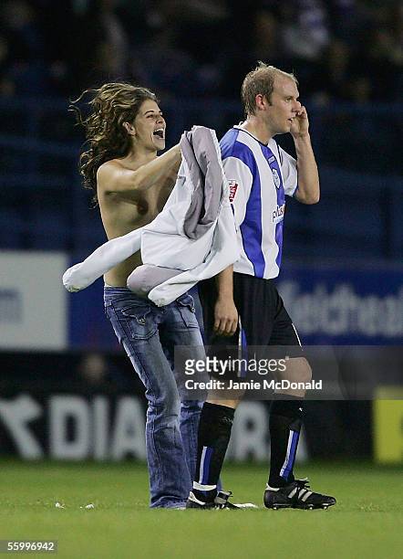 Streaker kisses John Hills of Sheffield during the Coca-Cola Championship match between Sheffield Wednesday and Brighton and Hove Albion at...