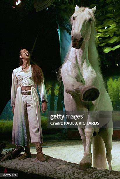 Arlington, UNITED STATES: Frenchman Frederic Pignon, equestrian co-director of Cavalia, commands Aetes, a white Spanish-Friesian stallion, as they...