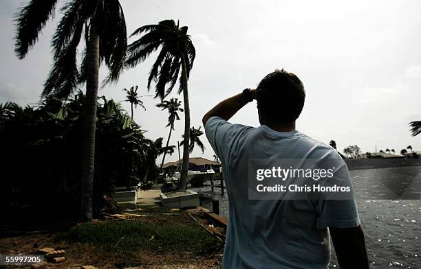 Resident Gunnar Thompson surveys the bay near his house after Hurricane Wilma roared through October 24, 2005 in Marco Island, Florida. Residents of...