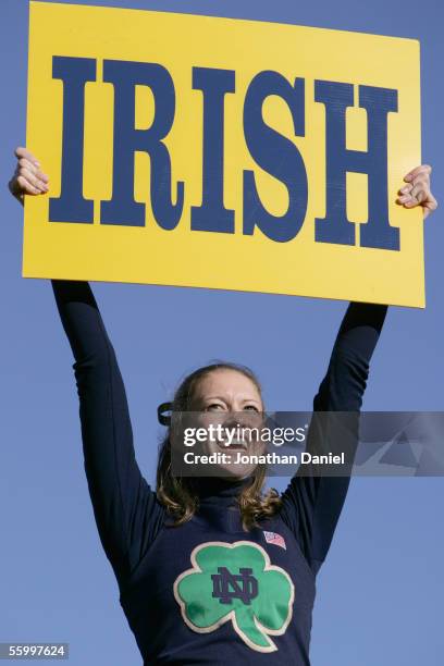 An University of Notre Dame Fighting Irish cheerleader holds an "Irish" sign during the game against the University of Southern California Trojans on...