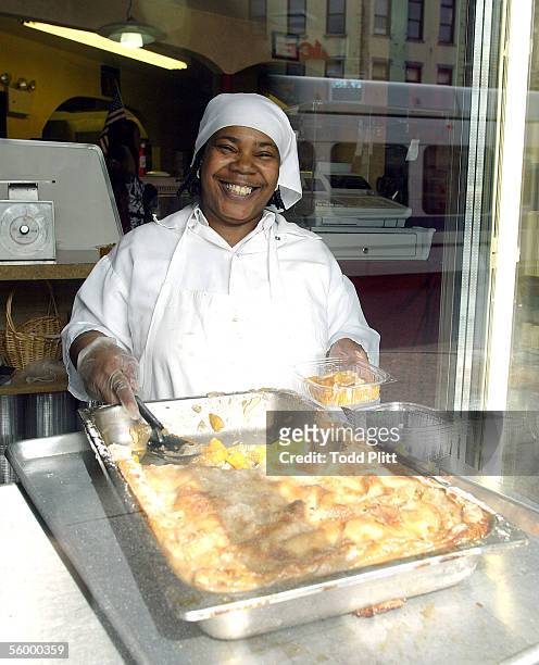 Unidentified worker displays some of the food served at Mama Duke Restaurant on the corner of Bergan Street and Flatbush Avenue on April 20, 2004 in...